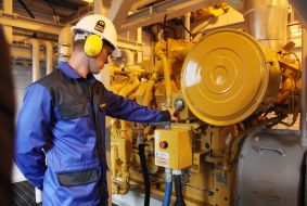 A worker checks the pressure in the gas pipe