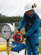 A worker checks the pressure in the gas pipe