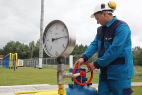 A worker checks the pressure in the gas pipe