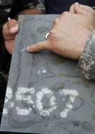 Bullet holes on the plate of body armor