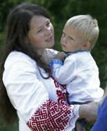 A woman holds a boy in her arms