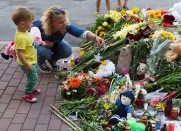 People bring flowers to the Embassy of the Netherlands