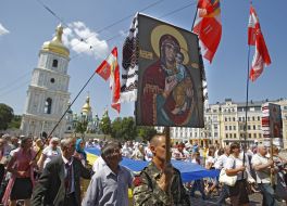 Believers carry a huge flag of Ukraine