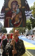 Believers carry a huge flag of Ukraine