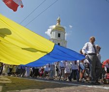 Believers carry a huge flag of Ukraine