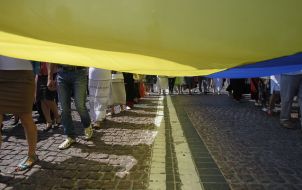 Believers carry a huge flag of Ukraine