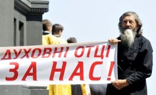Believer holds a placard