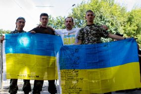 Military holding flags of Ukraine