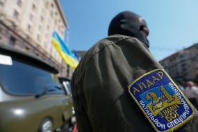 Battalion "Aydar" soldier near vehicles