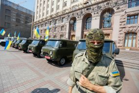 Battalion "Aydar" soldier near vehicles