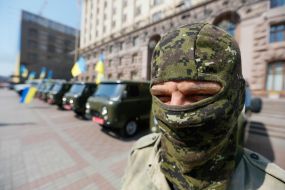 Battalion "Aydar" soldier near vehicles