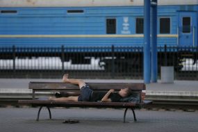 A man sleeps on a bench