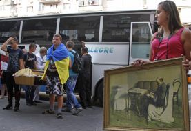 Activists hold a coffin