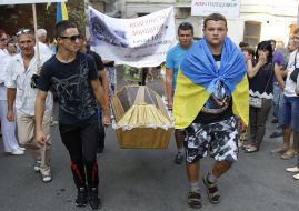 Activists hold a coffin