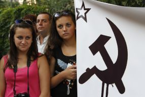 Protesters hold a poster