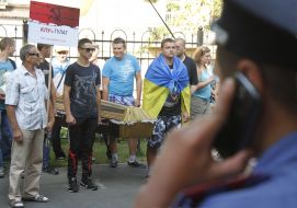 Activists hold a coffin