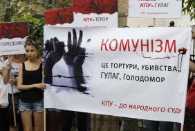 Protesters hold a poster