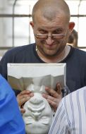 Activist holds an inverted bust of Lenin