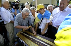 Activists drive nails in the coffin