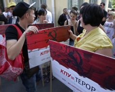 Protesters hold a poster