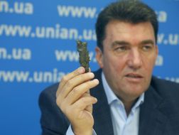 Aleksey Danilov shows a fragment of shell
