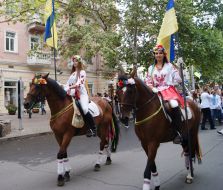 Girls in traditional costumes on horseback