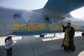 A priest consecrates the AN-26