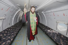 A priest consecrates the AN-26