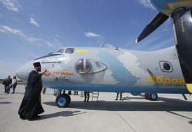 A priest consecrates the AN-26