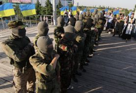 A priest blesses the volunteers