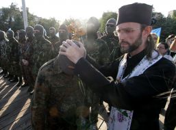 A priest blesses the volunteers