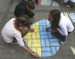 Children draw chalk on asphalt