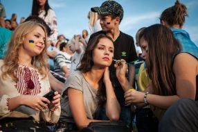Girl paint on cheek flag of Ukraine