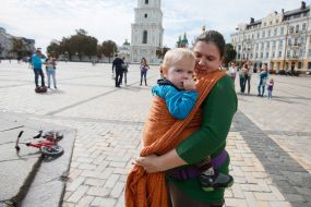 Mother with baby during the parade of Sling