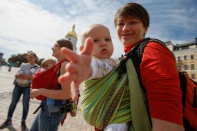 Mother with baby during the parade of Sling