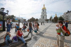 Mother with children during the parade of Sling