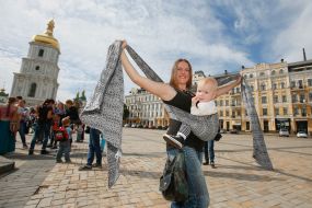 Mother with baby during the parade of Sling
