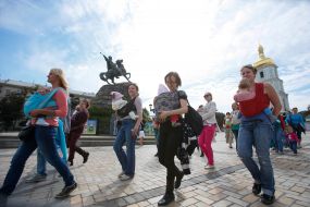 Mother with children during the parade of Sling