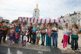 Mother with children during the parade of Sling