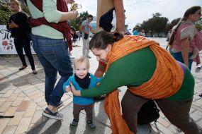 Mother with children during the parade of Sling