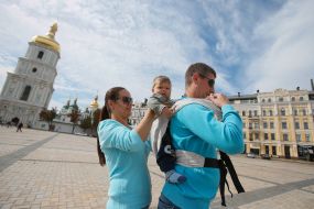 Mother with children during the parade of Sling