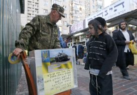 Hasidic boy at the box for fundraising
