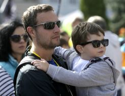 A man with a boy on his hands