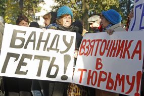 Activists hold placards