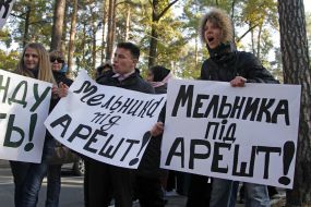 Activists hold placards