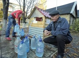 People collect water in plastic containers