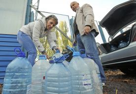 People collect water in plastic containers