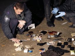 Militiamen inspect the seized things