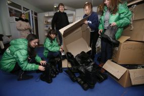 Volunteers sort the combat boots