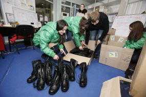 Volunteers sort the combat boots